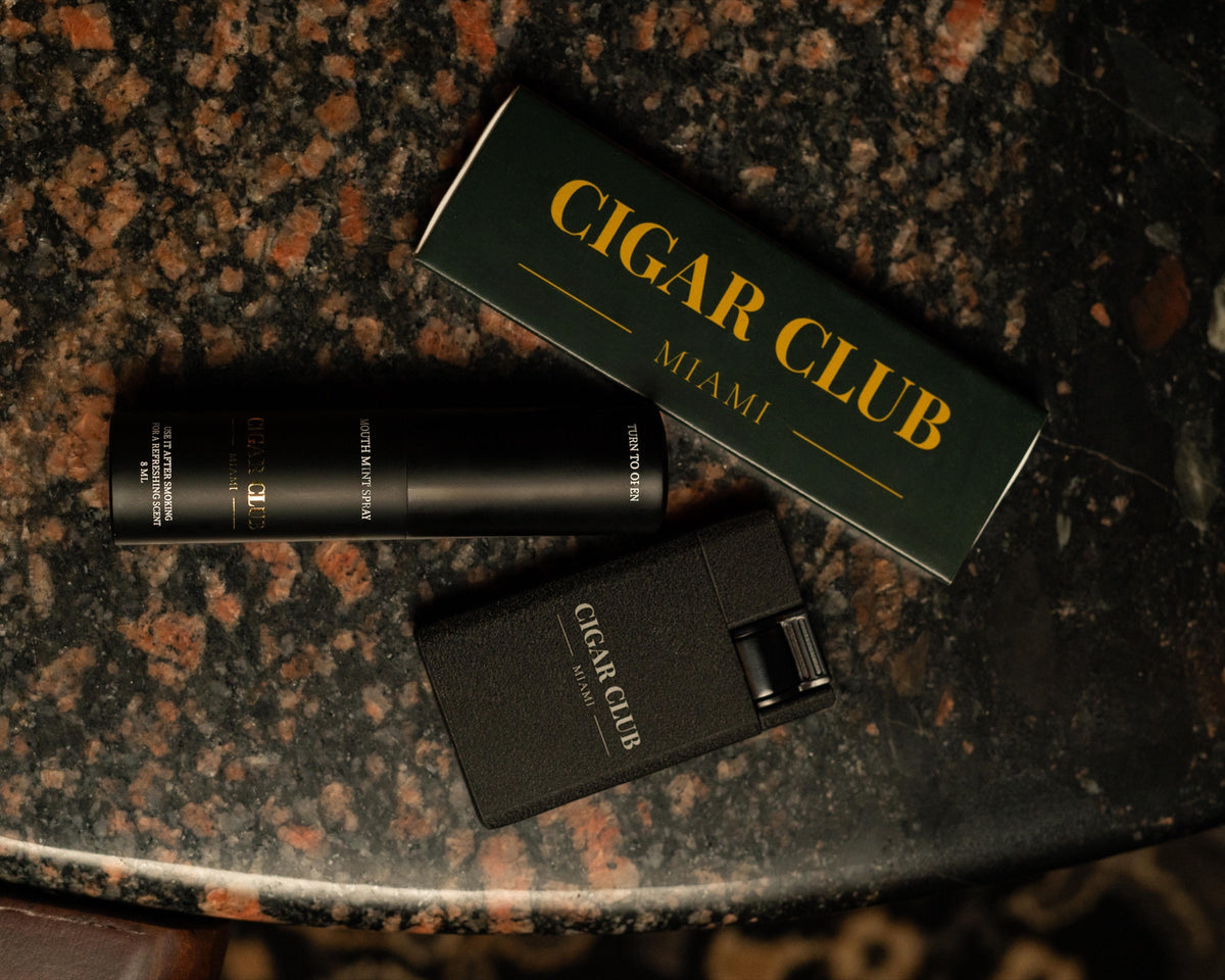 Cigar Club Miami branded lighter and cigar accessory on marble
